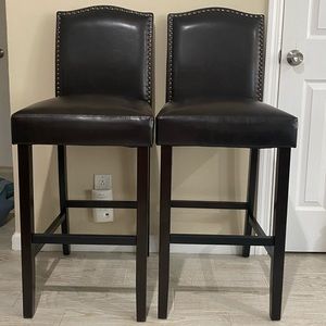 2 brown leather high top chairs
